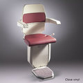 Sarum stairlift for curved stairs in red