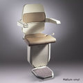 Sarum stairlift for curved stairs in brown