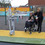 Hoist from wheelchair to trampoline